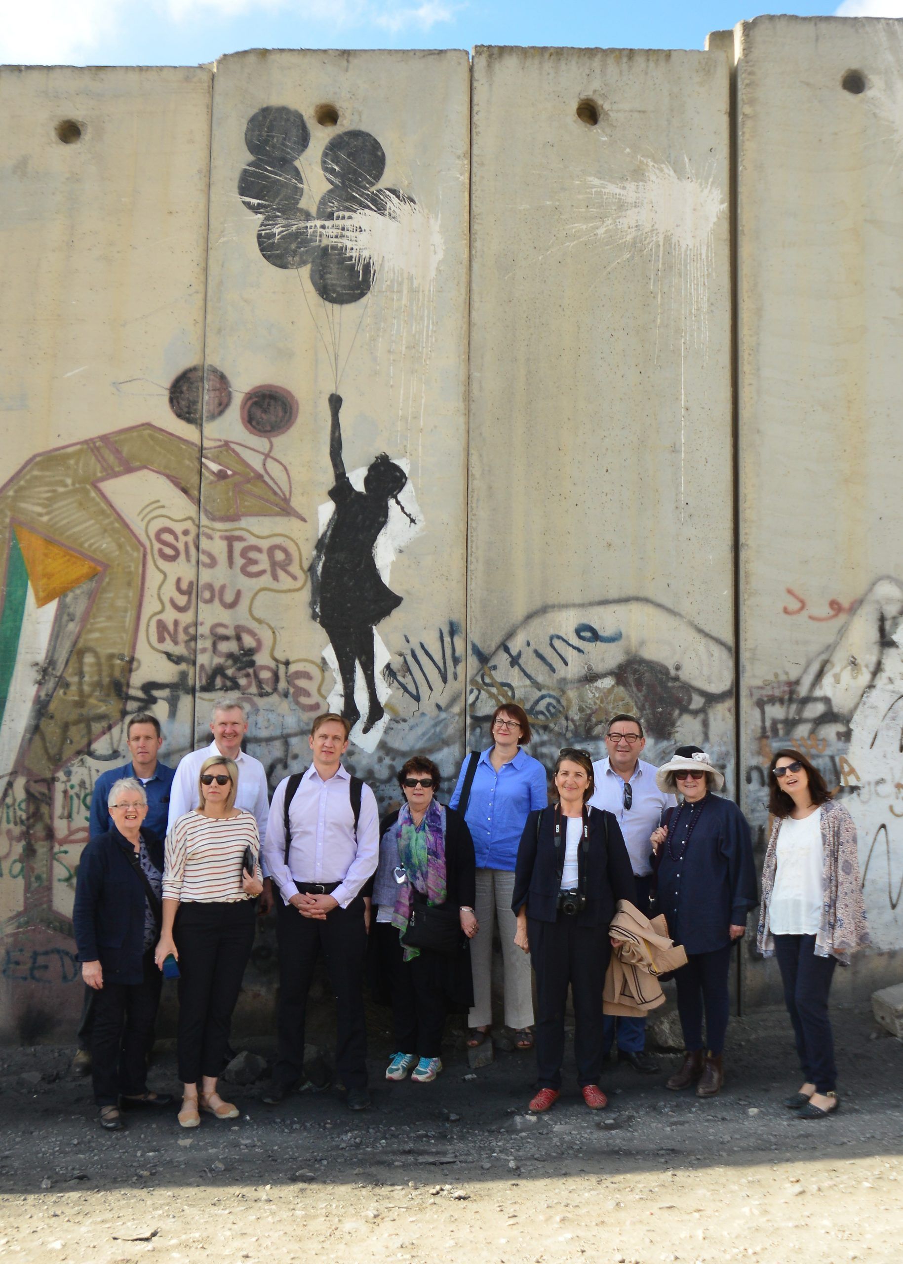 Photo of people beside Israel's Separation wall