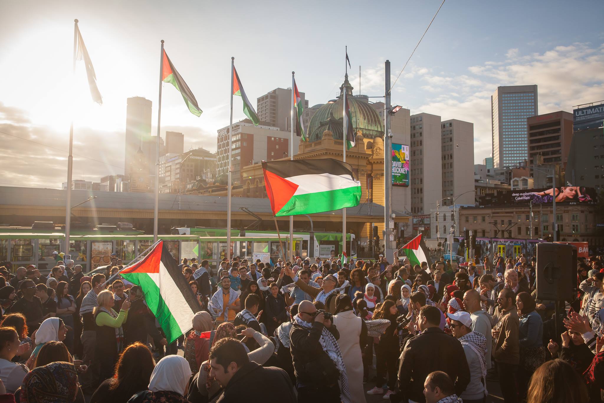Large group of people with Palestinian flags
