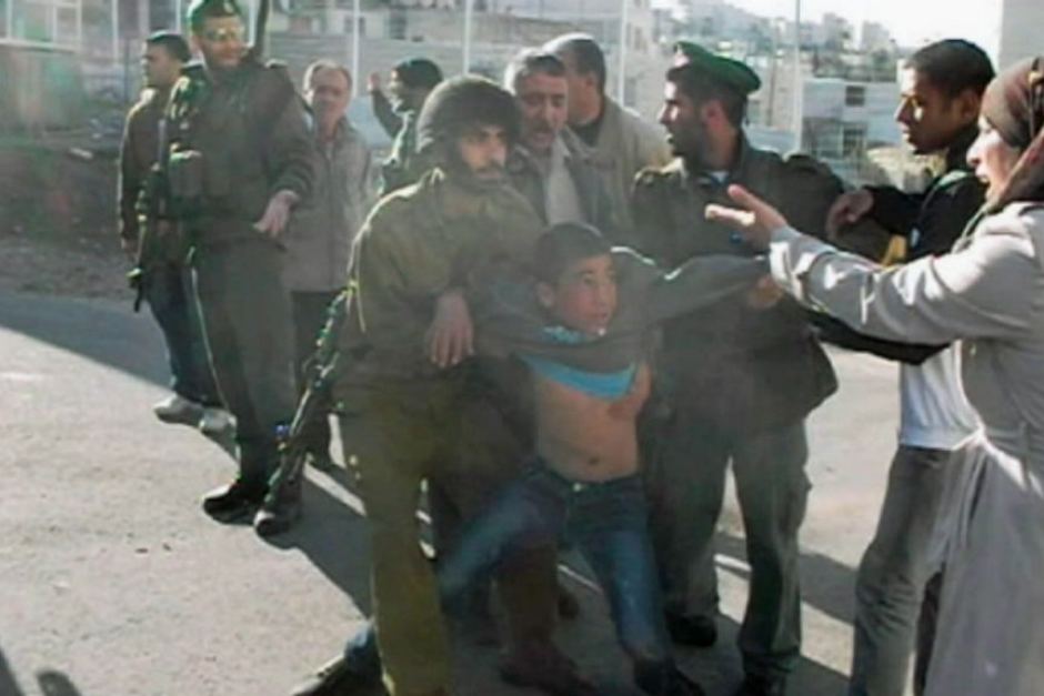 Photo of boy about 10yrs old being arrested by multiple Israeli soldiers