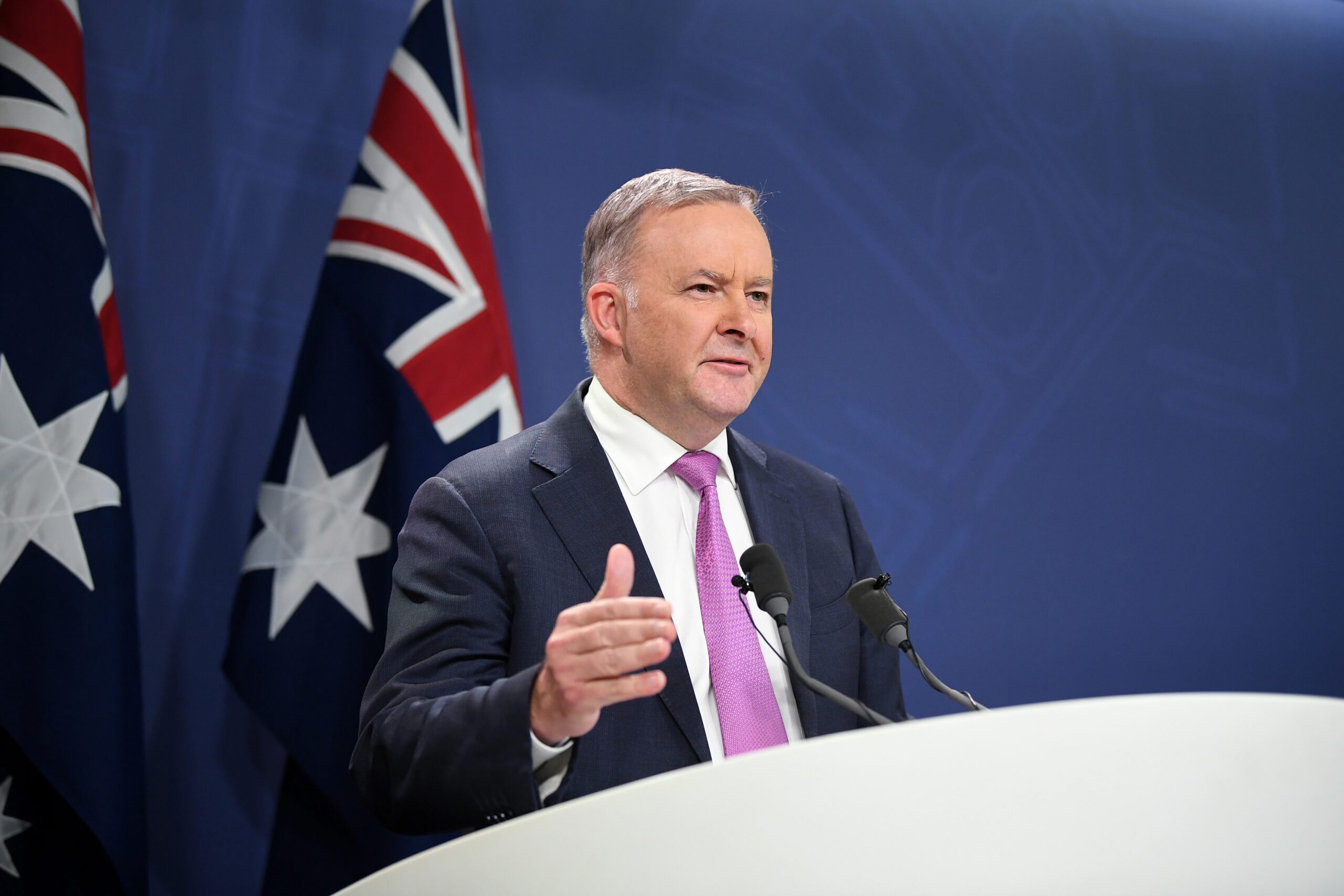 Anthony Albanese with Australian flgas in background