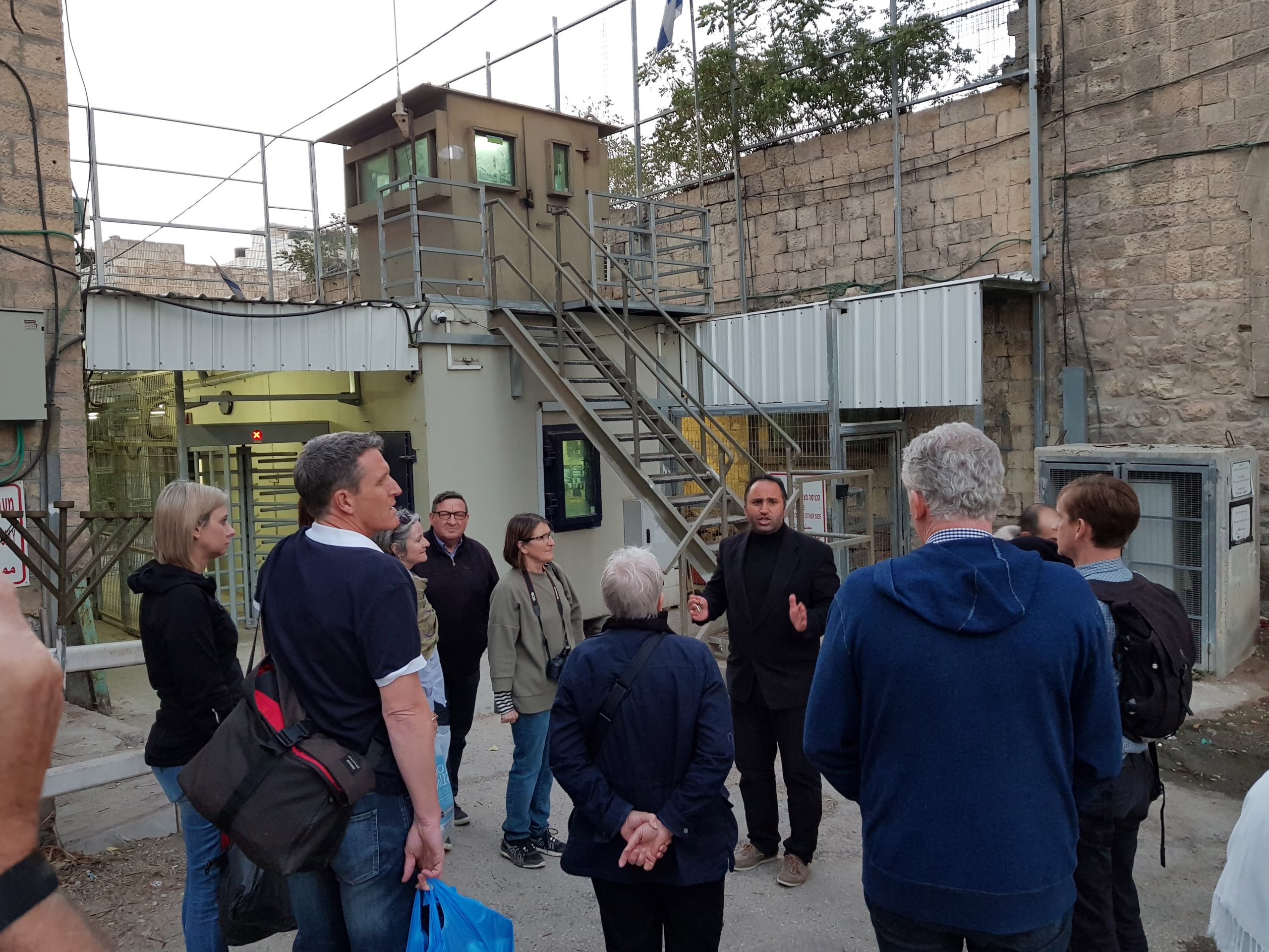 Photo at a Palestinian checkpoint with a Palestinian talking to group of Australians