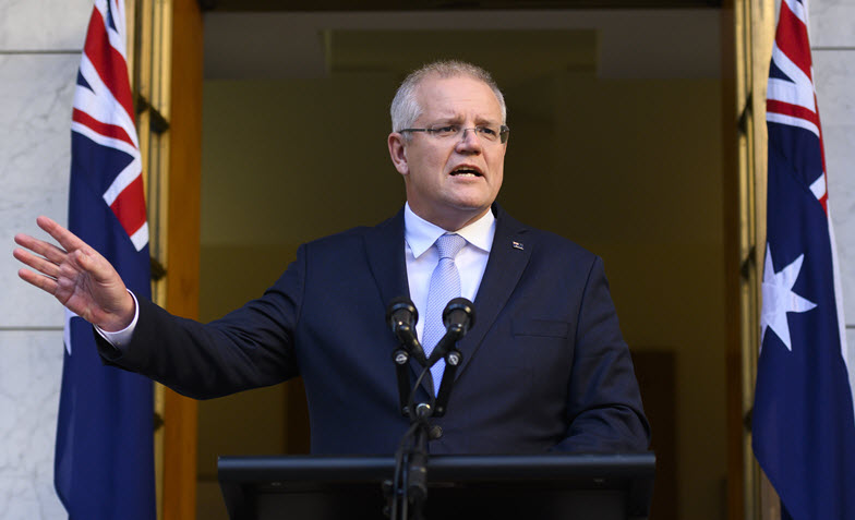 Photo of Prime Minister Scott Morrison at a podium with Australian flags behind him