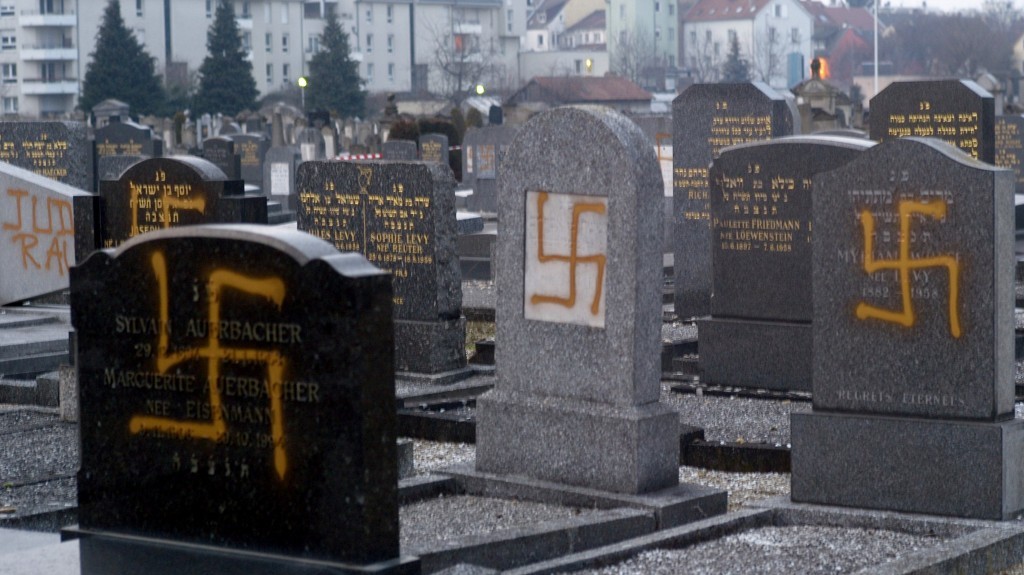 Photo of gravestones with nazi logo on them