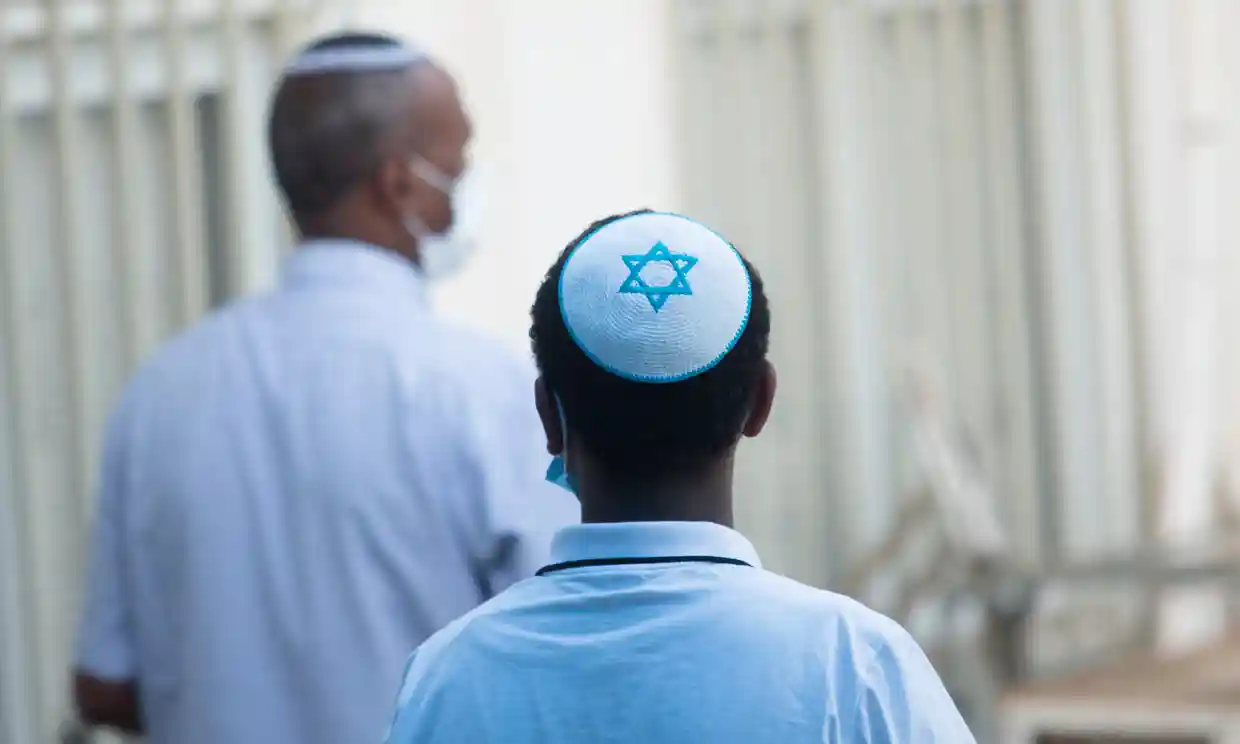 Photo of someone wearing a kippah with the Star of David